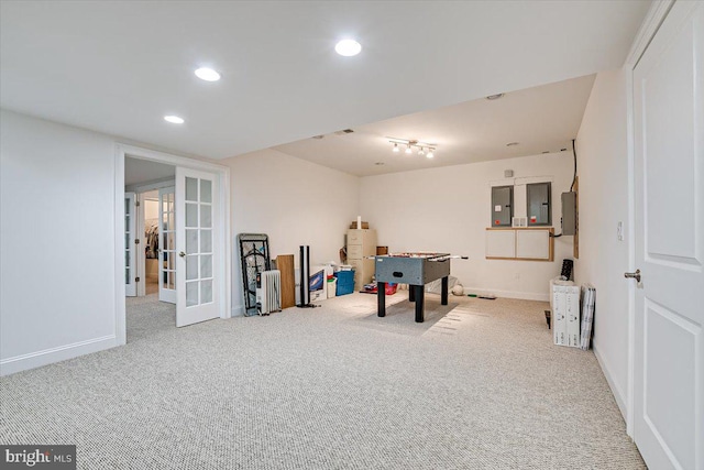 playroom featuring light colored carpet, water heater, electric panel, and french doors