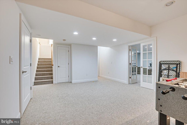 rec room featuring light colored carpet and french doors