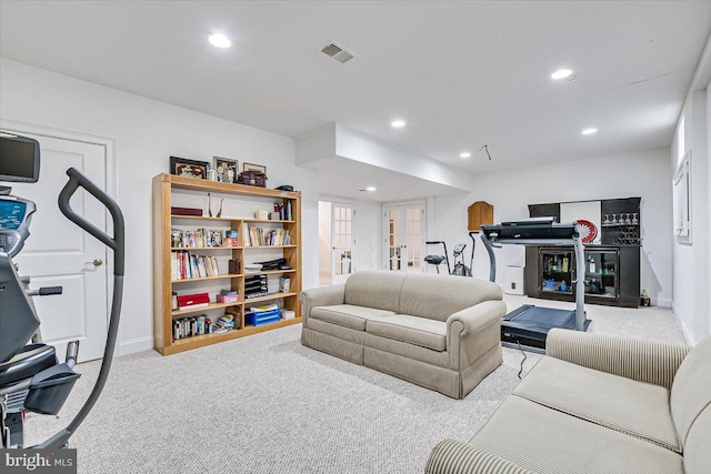 living room featuring light colored carpet and french doors