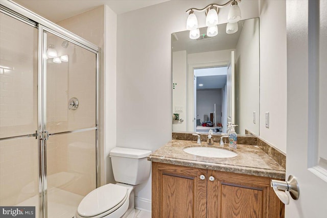 bathroom with vanity, toilet, and an enclosed shower