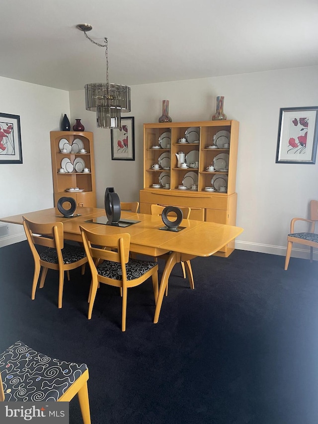 carpeted dining space featuring an inviting chandelier