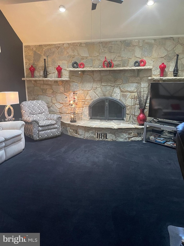 living room with ceiling fan, carpet flooring, lofted ceiling, and a fireplace