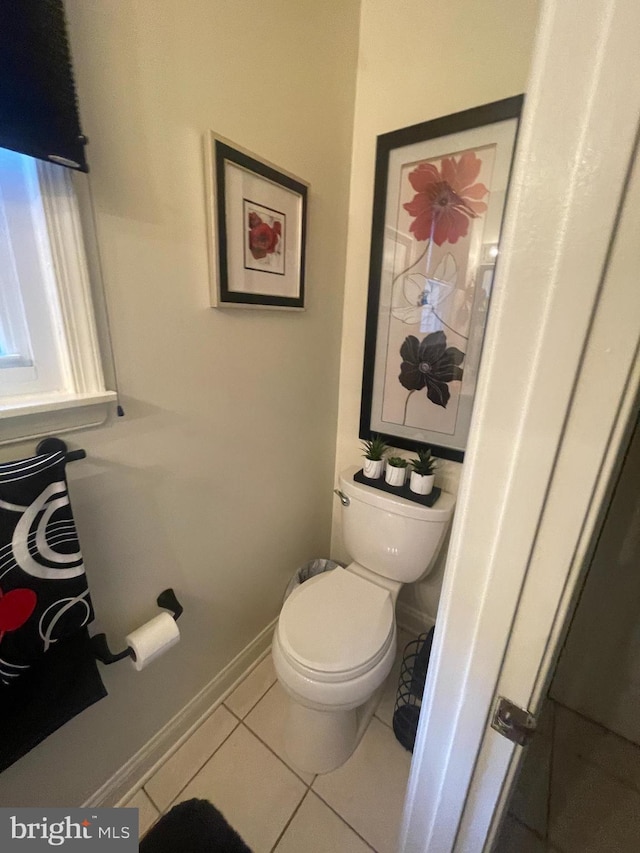 bathroom featuring toilet and tile patterned flooring