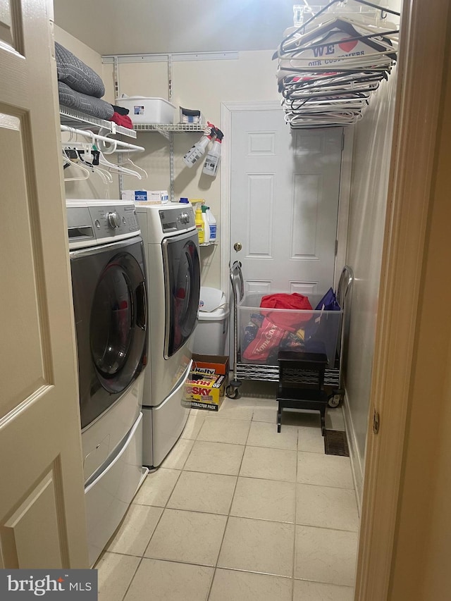 laundry area featuring independent washer and dryer and light tile patterned floors