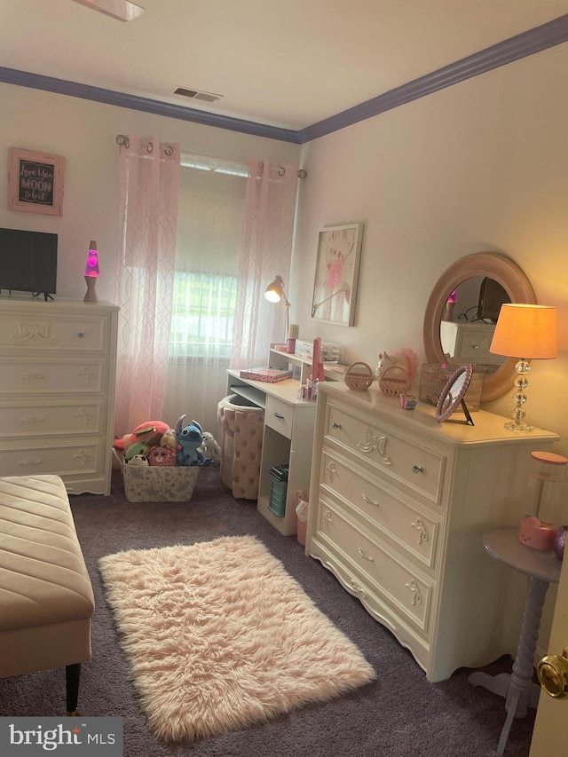 bedroom with ornamental molding and dark carpet