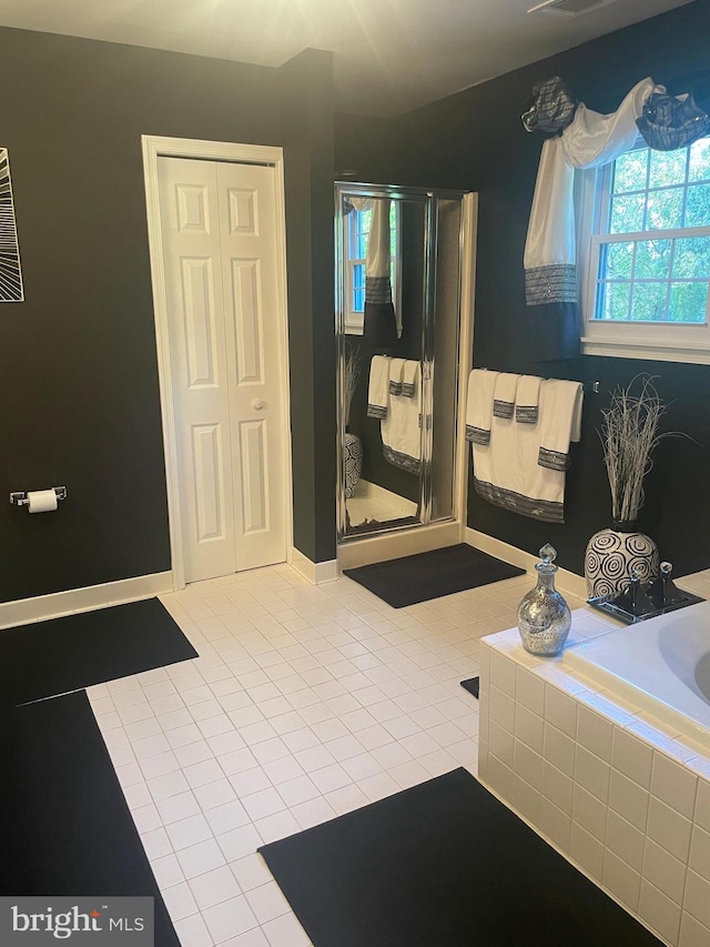 bathroom with plus walk in shower and tile patterned flooring