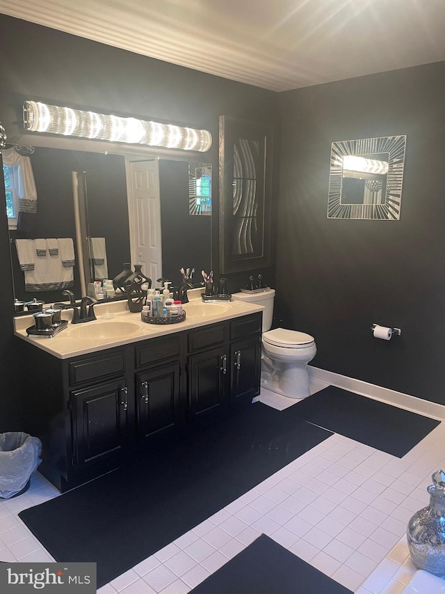 bathroom with vanity, toilet, and tile patterned flooring