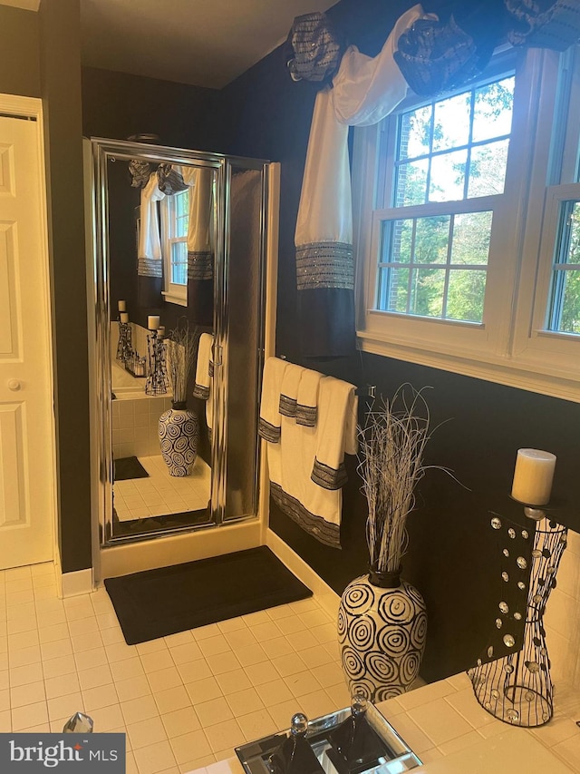 bathroom with tile patterned floors and walk in shower