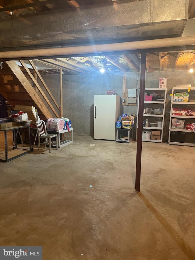 basement featuring white fridge