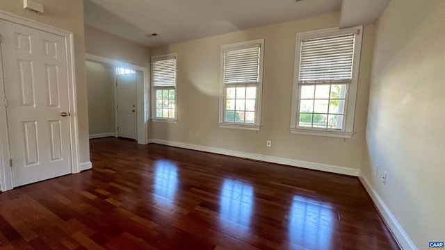 spare room with dark hardwood / wood-style flooring