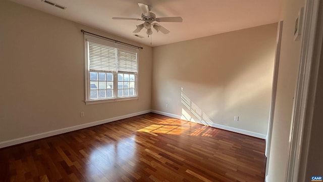 spare room featuring ceiling fan and dark hardwood / wood-style flooring