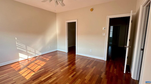 interior space with dark hardwood / wood-style flooring and ceiling fan