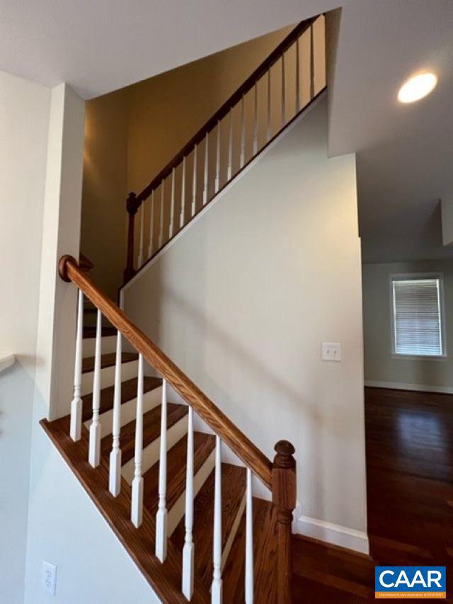 stairs with hardwood / wood-style flooring