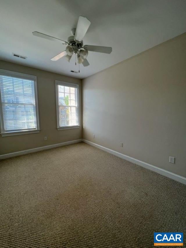 spare room featuring ceiling fan and carpet flooring