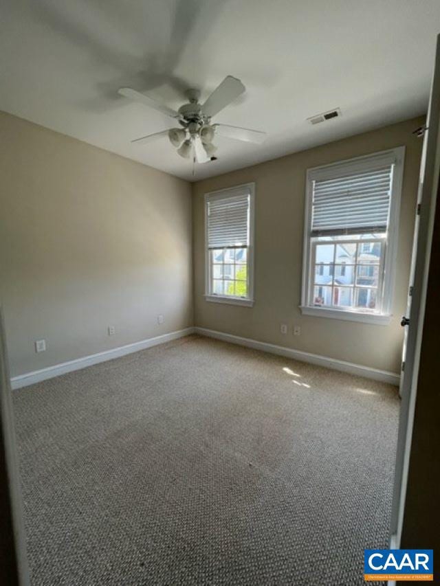 spare room with ceiling fan and carpet floors