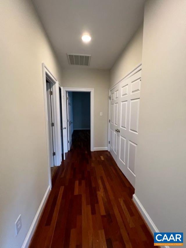 hall with dark hardwood / wood-style flooring