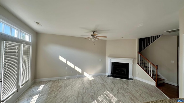 unfurnished living room featuring ceiling fan