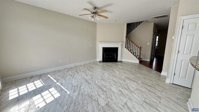 unfurnished living room featuring ceiling fan