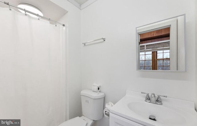 bathroom featuring vanity, toilet, and a shower with curtain