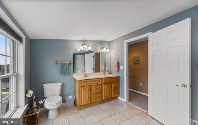 bathroom with lofted ceiling, tile patterned floors, vanity, and toilet