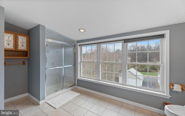 bathroom with a wealth of natural light, vaulted ceiling, and toilet