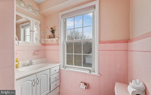 bathroom featuring tile walls and vanity