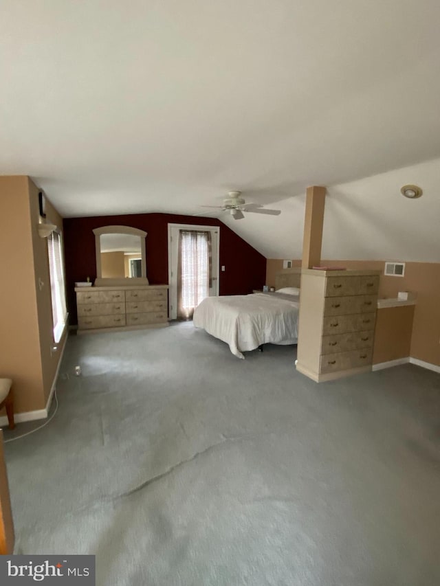 unfurnished bedroom with carpet, lofted ceiling, and ceiling fan