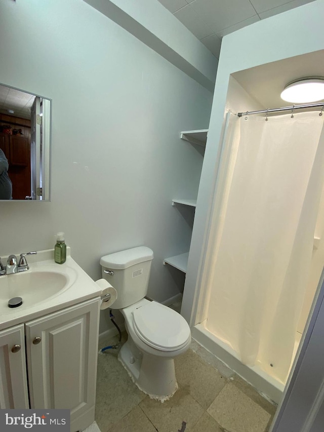 bathroom featuring walk in shower, vanity, toilet, and tile patterned floors