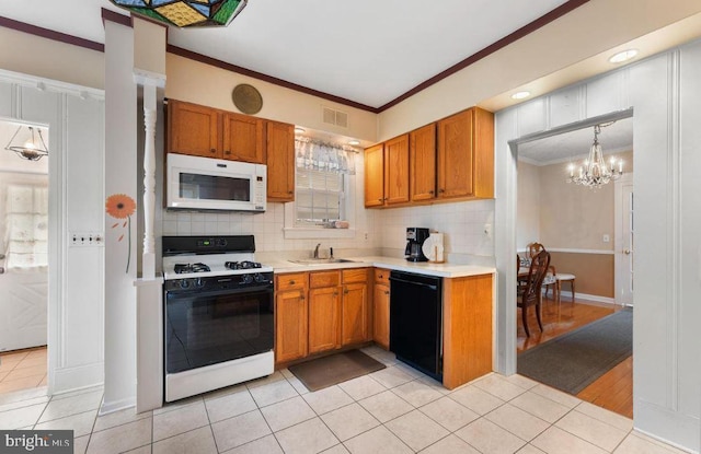 kitchen with backsplash, white appliances, crown molding, an inviting chandelier, and sink