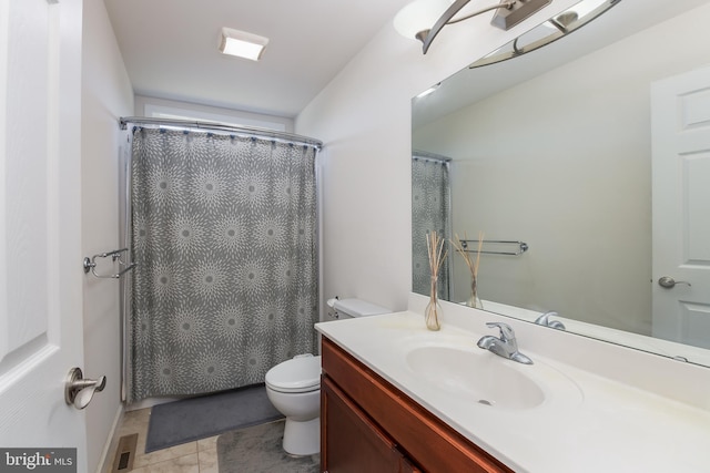 bathroom with a shower with curtain, vanity, toilet, and tile patterned floors