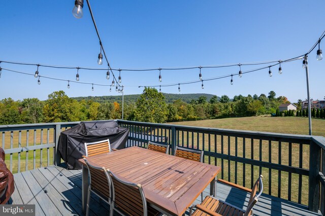 wooden terrace with grilling area and a yard