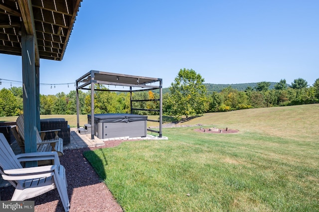 view of yard with a patio area and a hot tub