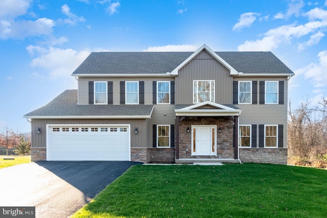 view of front of property featuring a front lawn and a garage