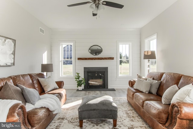 living room featuring light hardwood / wood-style floors and ceiling fan