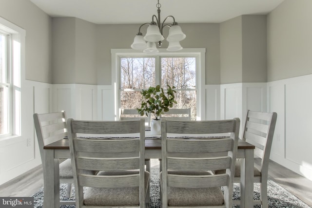 dining room with an inviting chandelier and hardwood / wood-style flooring