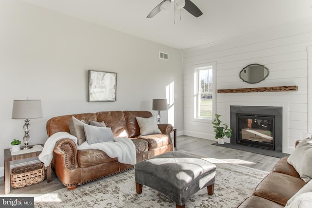 living room featuring ceiling fan and light hardwood / wood-style flooring