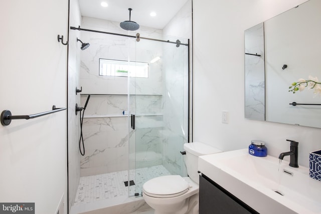 bathroom featuring vanity, toilet, and a shower with shower door