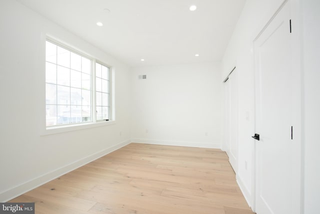 unfurnished bedroom with light wood-type flooring