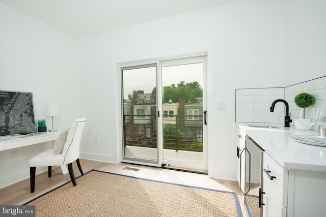 office featuring light hardwood / wood-style floors and sink