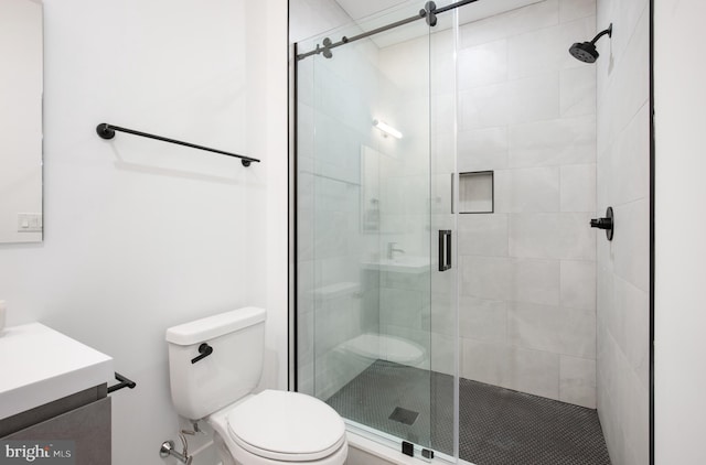 bathroom featuring walk in shower, vanity, and toilet