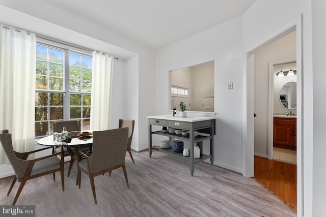 dining room featuring light wood-type flooring and sink