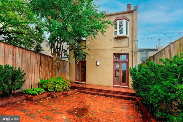 back of property featuring french doors and a patio area