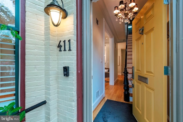 bathroom featuring hardwood / wood-style flooring and a chandelier