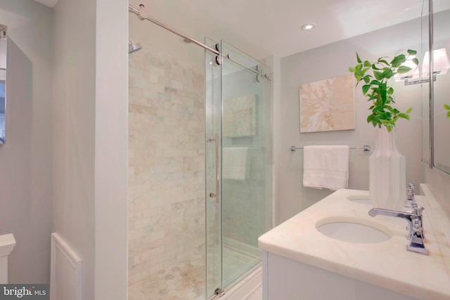 bathroom with vanity and a shower with shower door