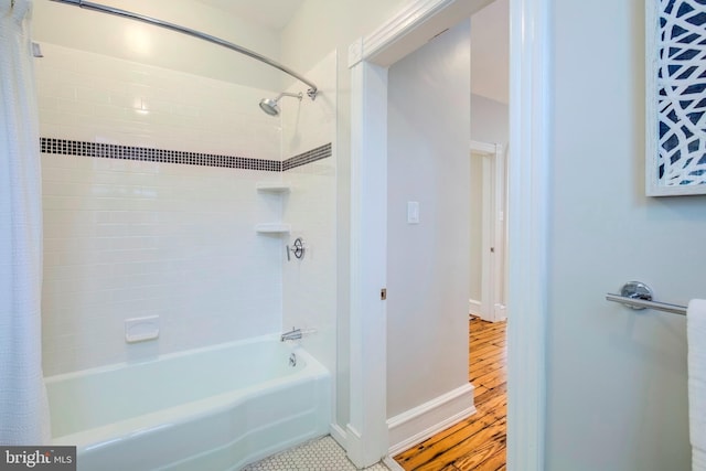 bathroom featuring shower / tub combo and hardwood / wood-style floors