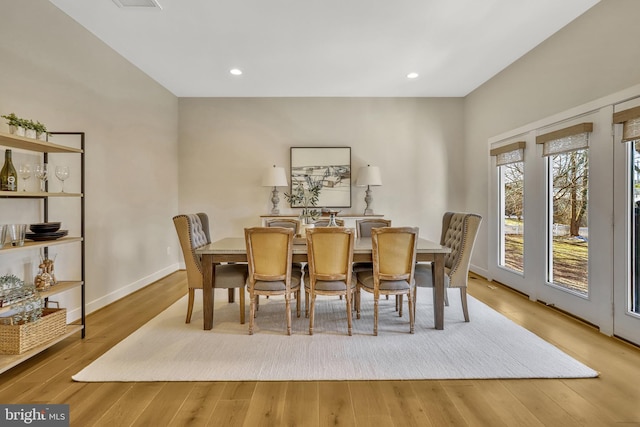 dining space with hardwood / wood-style floors