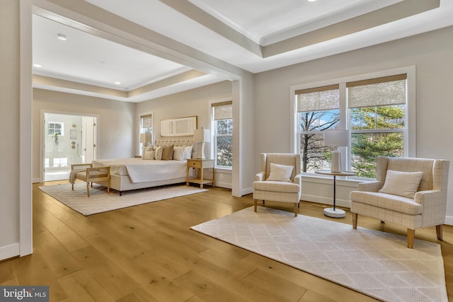 unfurnished bedroom featuring a raised ceiling and wood-type flooring