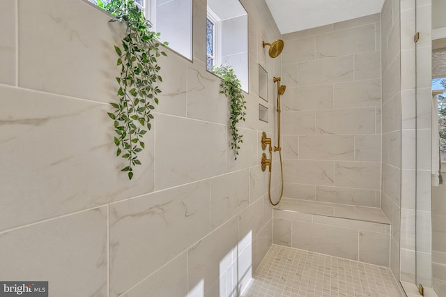 bathroom with a tile shower