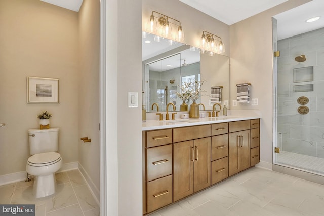 bathroom with toilet, vanity, and a shower with shower door