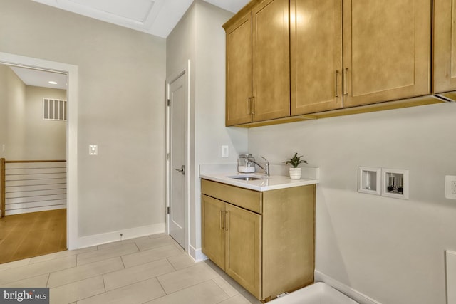 laundry room featuring washer hookup, sink, and cabinets